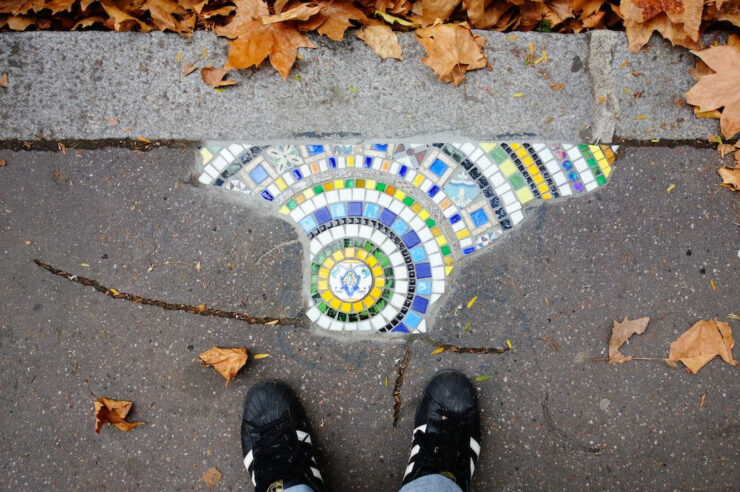 Image for The guerrilla artist filling Europe’s potholes with colourful mosaics